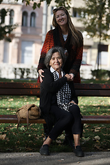 Image showing Elderly old cute woman with Alzheimer's very happy and smiling when eldest daughter hugs and takes care of her