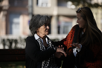 Image showing Elderly old cute woman with Alzheimer's very happy and smiling when eldest daughter hugs and takes care of her