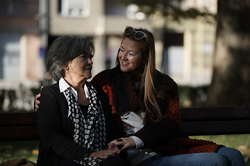 Image showing Elderly old cute woman with Alzheimer's very happy and smiling when eldest daughter hugs and takes care of her