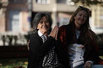 Image showing Elderly old cute woman with Alzheimer's very happy and smiling when eldest daughter hugs and takes care of her