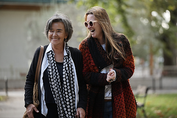 Image showing Elderly old cute woman with Alzheimer's very happy and smiling when eldest daughter hugs and takes care of her