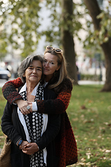 Image showing Elderly old cute woman with Alzheimer's very happy and smiling when eldest daughter hugs and takes care of her