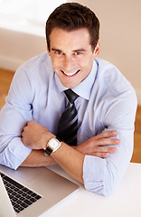 Image showing Portrait of businessman at desk with smile, laptop and confidence for market research at startup. Office, computer and face of happy man at digital agency with pride, online trading and networking.