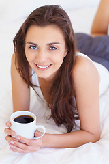 Image showing Coffee, bed and portrait of happy woman in morning, wake up or natural wellness in home on calm summer weekend. Relax, drink and peace, smile on face and girl in apartment, bedroom or house with rest