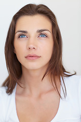 Image showing Woman, beauty and thinking of natural skincare on a white studio background. Vision, face and attractive model with dermatology closeup for future thought on a backdrop with makeup and cosmetics