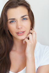 Image showing Woman, portrait and serious in studio with beauty, cosmetics treatment and glowing skin on white background. Person, model and face with pride or calm for skincare and dermatology with confidence