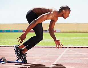 Image showing Man, runner and starting line for sprint, athlete and ready for marathon, wellness and race or competition. Black male person, training and exercising or active, practice and blocks for fitness