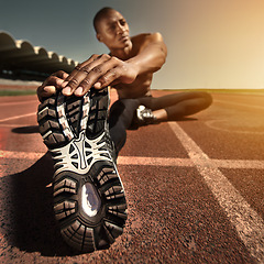 Image showing Man, face and stretching leg on ground, outdoors and fitness for health, sports and performance. Black male person, athlete and warmup on track, workout and commitment or ready, train and cardio