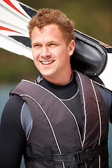 Image showing Sports, fitness and man by lake with wakeboard for surfing, exercise and recreation hobby outdoors. Happy, extreme sport and excited person with board for water skiing for freedom, adventure and fun