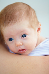 Image showing Family, shoulder and parent with baby in home for bonding, loving relationship and affection. Love, bedroom and closeup of mother carrying newborn for child development, growth and care in nursery