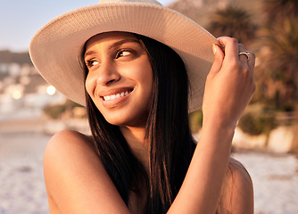 Image showing Woman, hat and beach smile at sunset or holiday vacation, tropical ocean break or happy travel. Indian person, sea tip and destination in evening or summer sunshine in peace relax, quiet time as rest