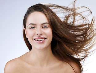 Image showing Hair care, woman or portrait and happy in studio with breeze, collagen treatment or brazilian for shine. Person, smile or cosmetics and dermatology, keratin or beauty on white background for wellness