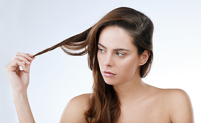 Image showing Hair care, woman and face or serious in studio with shampoo, collagen treatment or brazilian for shine. Person, confident and cosmetics with dermatology, keratin or beauty with white background