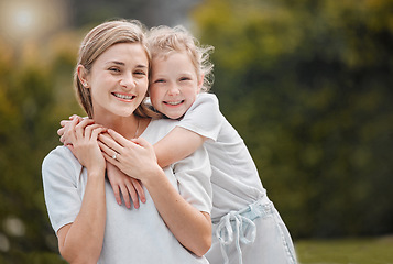 Image showing Nature, hugging and portrait of kid with mother in an outdoor garden bonding together. Happy, smile and girl child embracing her young mom from Canada with love and care in the park or field.