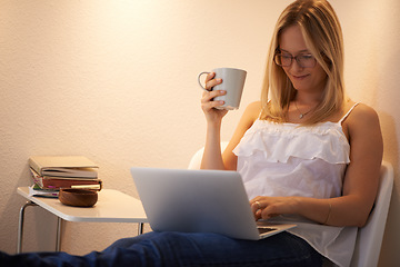 Image showing Happy woman, laptop and journalist with coffee in relax on chair reading, typing or writing in living room at home. Female person or freelancer smile on computer with tea cup in remote work at house