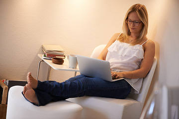 Image showing Woman, laptop and journalist typing in relax for online connection on chair in living room at home. Female person, freelancer or typist in remote work on lounge furniture for story writing at house