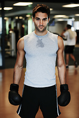 Image showing Man, boxing gloves and fitness with gym portrait for health, wellness or training for fight, performance or sport. MMA, boxer or strong for contest, competition or exercise for development with sweat