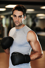 Image showing Man, boxing gloves and exercise with gym portrait for health, wellness or training for fight, performance or sport. MMA, boxer or strong for contest, competition or workout for development with sweat