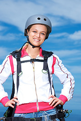 Image showing Woman, skydiver and gear in outdoors, adventure and recreation or extreme sports for fun or equipment. Female person, travel and outside in portrait, holiday and vacation or getaway, active and smile