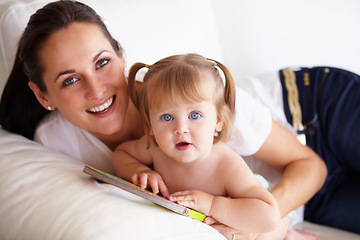 Image showing Baby, mother and portrait or smile on sofa with children book, relax and parenting in living room of home. Family, woman and girl child with happiness on couch in lounge for development, love or care