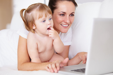 Image showing Family, laptop for remote work with a mother and baby in the bedroom of a home together to multitask. Computer, freelance or childcare with a woman parent and her girl toddler on an apartment bed
