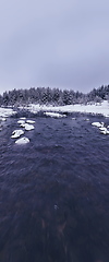 Image showing Amazing Cinematic Aerial View On Freezing River. Aerial View Flight Above Frozen Creek Scenic View Of Nature