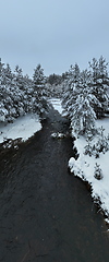 Image showing Amazing Cinematic Aerial View On Freezing River. Aerial View Flight Above Frozen Creek Scenic View Of Nature