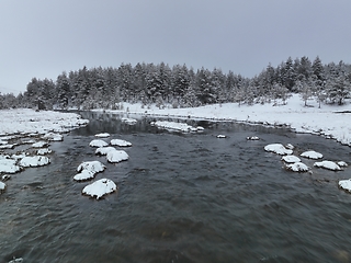 Image showing Amazing Cinematic Aerial View On Freezing River. Aerial View Flight Above Frozen Creek Scenic View Of Nature