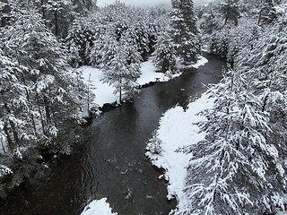 Image showing Amazing Cinematic Aerial View On Freezing River. Aerial View Flight Above Frozen Creek Scenic View Of Nature