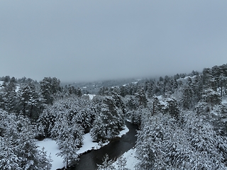 Image showing Amazing Cinematic Aerial View On Freezing River. Aerial View Flight Above Frozen Creek Scenic View Of Nature