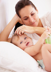 Image showing Baby, mother and portrait or smile on bed with bottle, relax and parenting in bedroom of home with security. Family, woman or girl kid with happiness in nursery for development, love or care in house