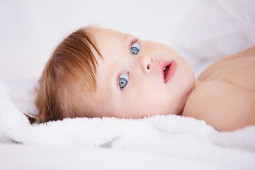 Image showing Portrait, growth and child development with a baby in the bedroom to relax alone in the morning. Face, kids or youth and an adorable young infant girl on a bed with blankets for comfort in a home