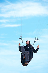 Image showing Man, parachute and paragliding in air nature for exercise, healthy adventure with extreme sport. Athlete, glide or fearless for outdoor fitness for health wellness, helmet or safety gear by blue sky