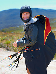 Image showing Paragliding, parachute or man in nature in portrait, smile or strings for exercise for health support. Athlete, face and training with happy for outdoor fitness, helmet and equipment in countryside