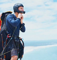 Image showing Preparation, parachute or man with helmet for sport, safety or gear to exercise for health wellness. Sky mockup, equipment or fitness in nature for outdoor training, fearless or countryside adventure