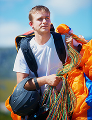 Image showing Safety, parachute and man in nature for sport, equipment and strings for exercise for health support. Athlete, ready or training with fitness for outdoor wellness, helmet or harness in countryside