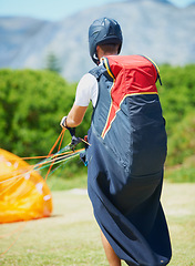 Image showing Nature, man and parachute with ground for sport preparation, strings and training for paragliding exercise. Person, safety gear and helmet for outdoor fitness with toggle, fearless and countryside