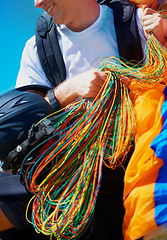 Image showing Equipment, parachute or man in nature for sport, positive or strings for exercise for health support. Athlete, happy or training preparation with outdoor for wellness, helmet or summer in countryside