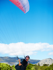 Image showing Man, parachute or paragliding sport in preparation exercise, healthy adventure or extreme fitness. Person, launch or fearless for outdoor flight in health wellness, helmet or safety gear by blue sky