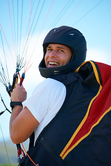 Image showing Man, parachute or launch in nature for sport, happy or exercise for healthy adventure for extreme fitness. Person, strings or smile for outdoor fun in wellness, helmet or safety gear in countryside