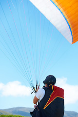 Image showing Nature, sport or man with parachute in preparation, launch or paragliding training for adventure in extreme exercise. Person, balance or strings for outdoor fun or fitness with helmet or safety gear