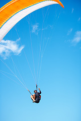 Image showing Man, paragliding and blue sky adventure fun in clouds for explore city, outdoor courage or fearless athlete. Male person, parachute and mockup space or safety equipment for landing, flying in nature