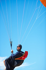 Image showing Man, portrait and paragliding in blue sky parachute for adventure fun, clouds or explore city. Male person, face and outdoor courage for fearless athlete or landing equipment, air safety in nature
