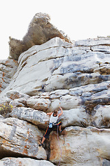 Image showing Woman, rock climbing and mountain or rope explore for grip strength, stone cliff or sports challenge. Female person, boulder hill and gear for outdoor peak safety or healthy fear, risk or fit danger