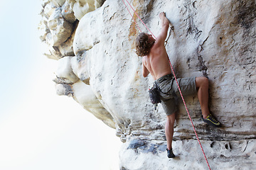 Image showing Man, rock climbing and mountain rope adventure or sports challenge, risk performance on stone crack. Male person, hanging and outdoor cardio gear or courage as fearless athlete, brave danger on cliff