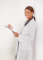 Image showing Doctor portrait, woman with folder and writing in medical documents, report or information of patient history in clinic. Happy healthcare worker with hospital charts or checklist on a wall background