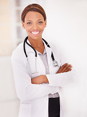 Image showing Portrait, black woman and doctor with arms crossed, smile and confident employee with a stethoscope, lab coat and hospital. Face, African person and medical with professional, physician or healthcare