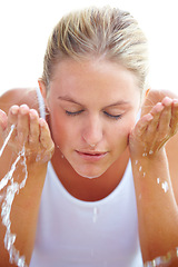 Image showing Skincare, washing face and woman with water in studio for hygiene, wellness and facial treatment. Spa, dermatology and person with liquid splash for cleaning, beauty and health on white background