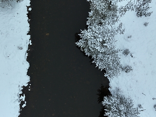 Image showing Amazing Cinematic Aerial View On Freezing River. Aerial View Flight Above Frozen Creek Scenic View Of Nature