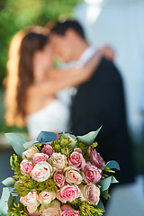 Image showing Bouquet, happy couple and embrace at wedding with love, smile and commitment at reception event. Roses, woman and man hugging at marriage celebration flowers, partnership and future together.